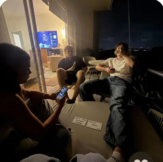 Friends on a sofa with cards on the table