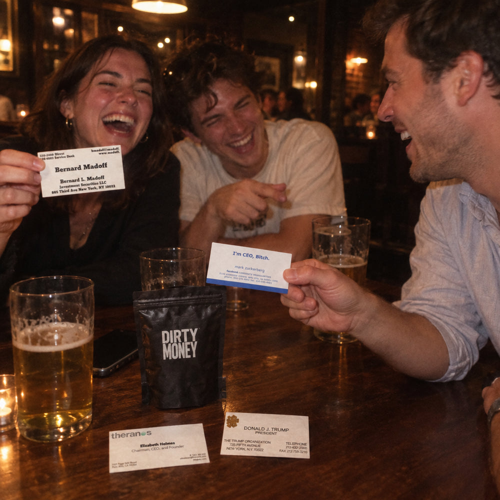 Friends in a bar laughing over founder cards